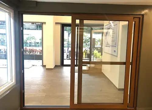 Laminated sliding door with mesh shutter in Golden Oak