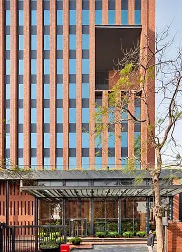 The design for Max House, an office building for Max Estates in New Delhi, incorporates several design features to reduce its environmental impact